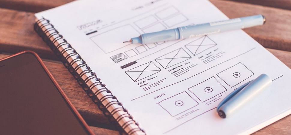 wireframe of a website page layout drawn on a notepad