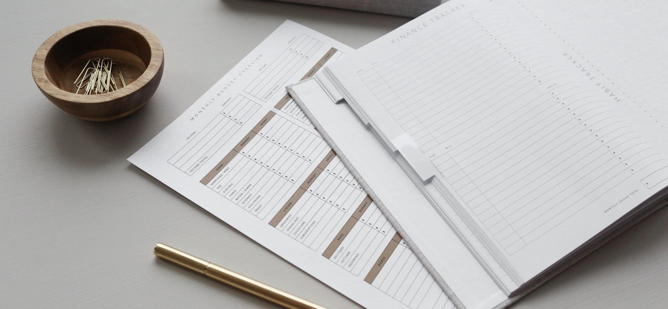 monthly budget and finance tracking documents lying on a table