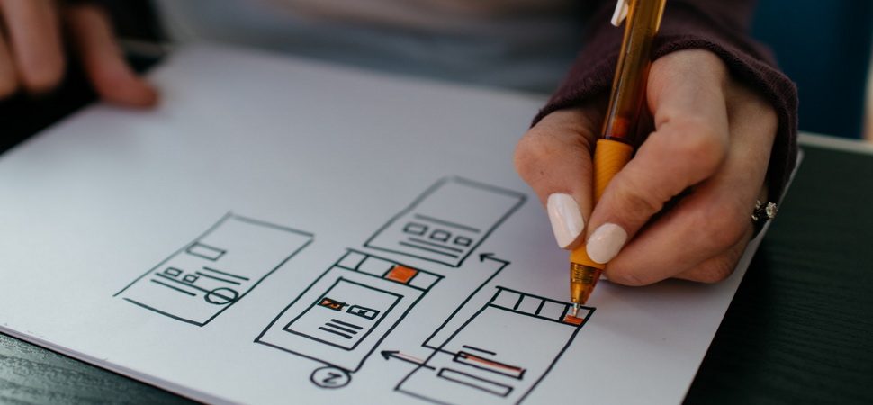 female hand wireframing the layout of a digital application